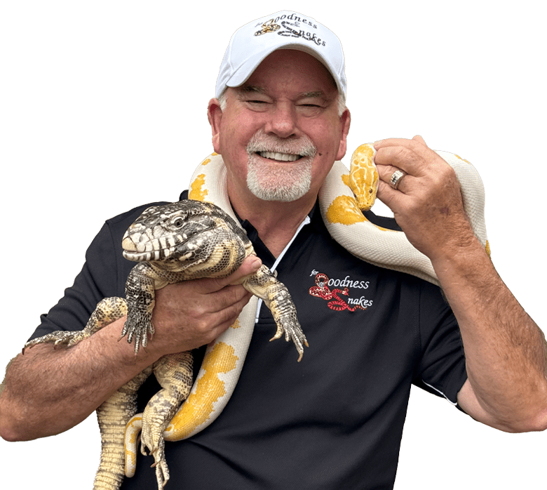A man holding two snakes and a turtle.