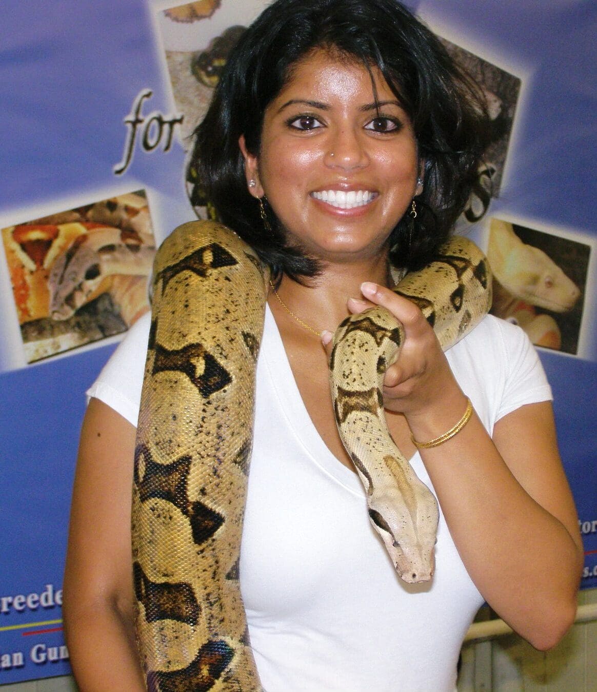 A woman holding a snake in her hand.